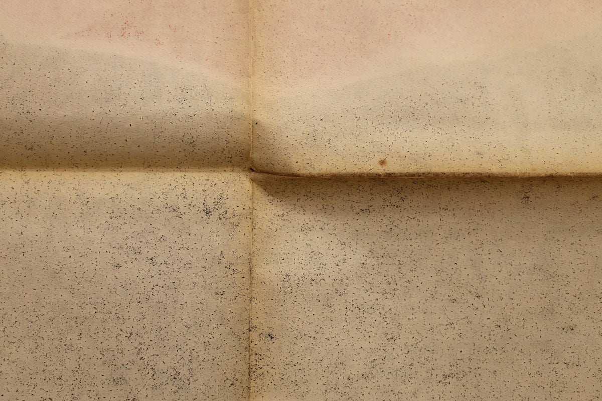 Close-up of the reverse showing intersecting horizontal and vertical folds with localized wear and soiling.