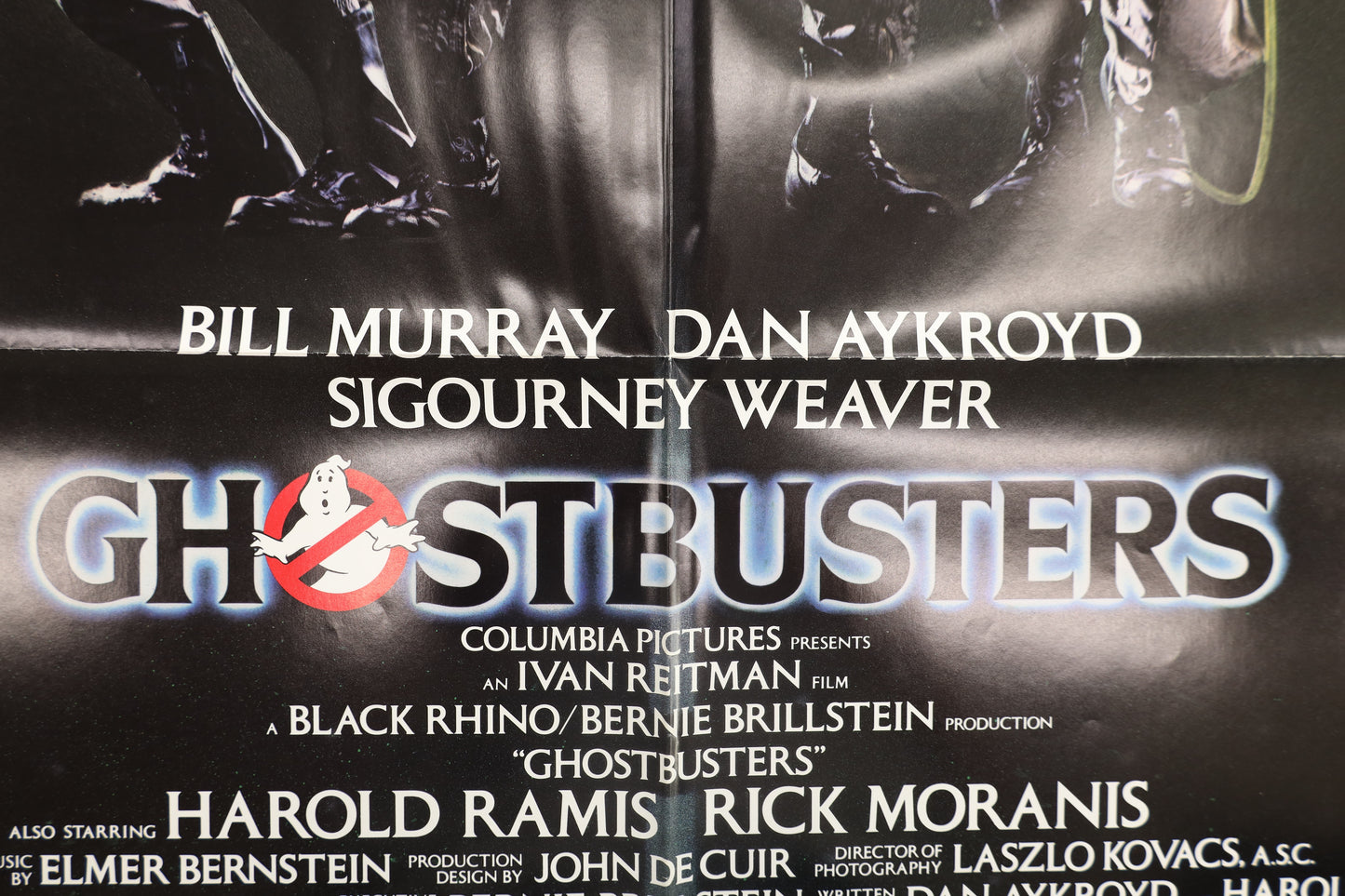 Close-up of Ghostbusters (1984) advance one sheet movie poster showing the Ghostbusters title, cast credits, and fold detail.