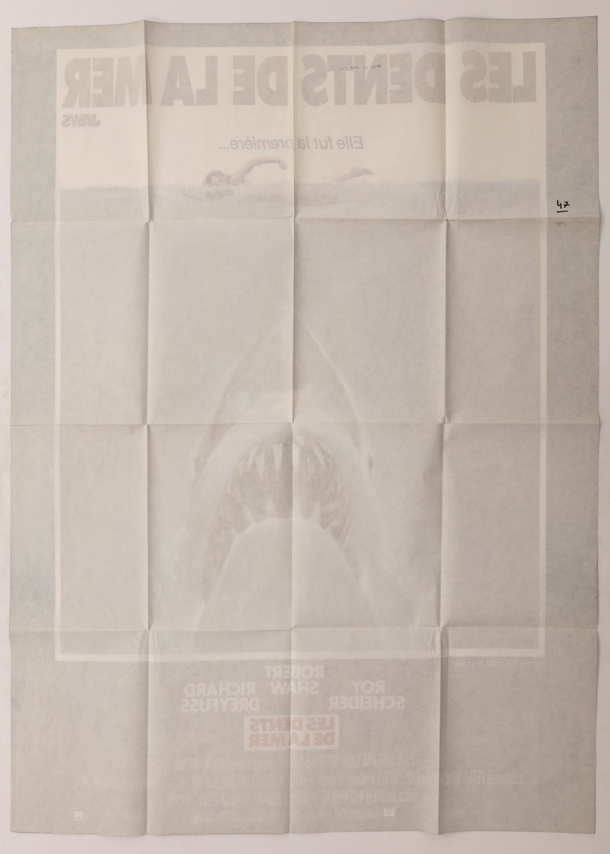 Back of original Jaws (1975) French Grande movie poster showing fold lines, reverse printing, and handwritten notations.