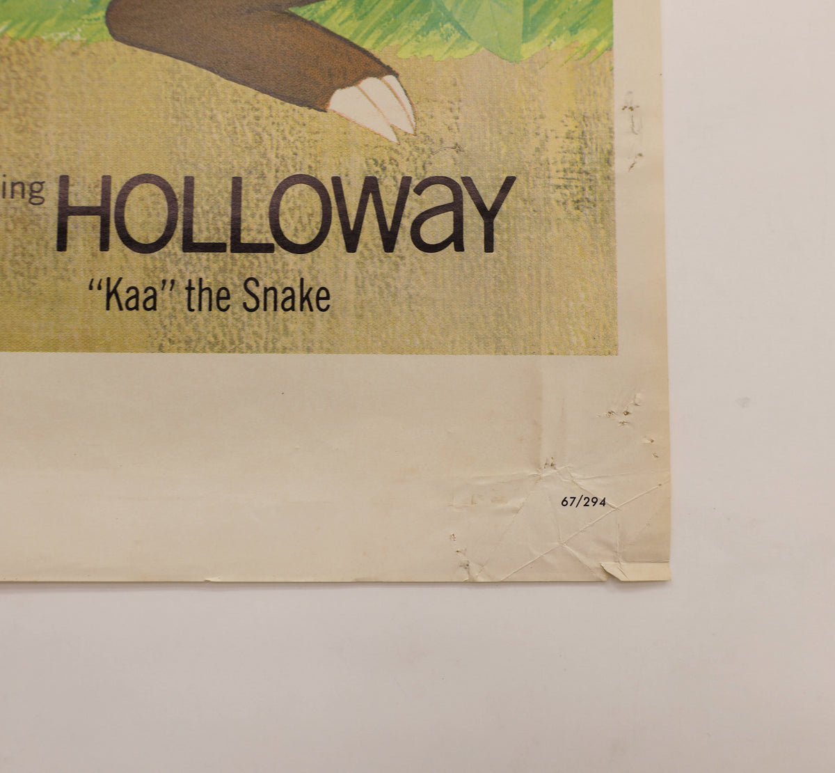 Detail of The Jungle Book 1967 one sheet poster showing creasing, small tears and paper wear near the lower-right corner and NSS number 67/294.