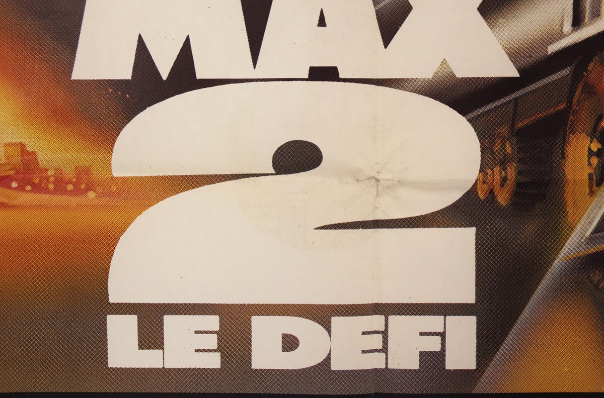 Close-up of Mad Max 2 French poster artwork showing the title and visible crease