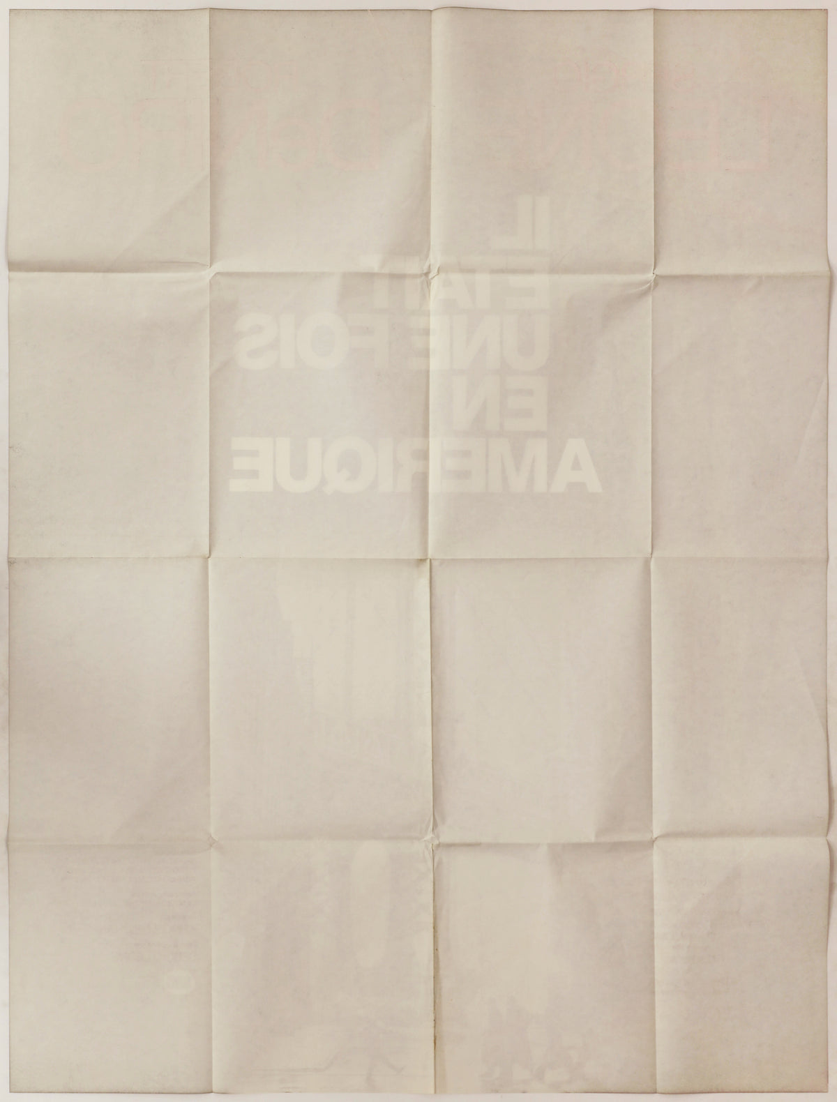 Full reverse of the folded poster showing a grid of fold lines, light toning, and faint bleed-through of the front design.