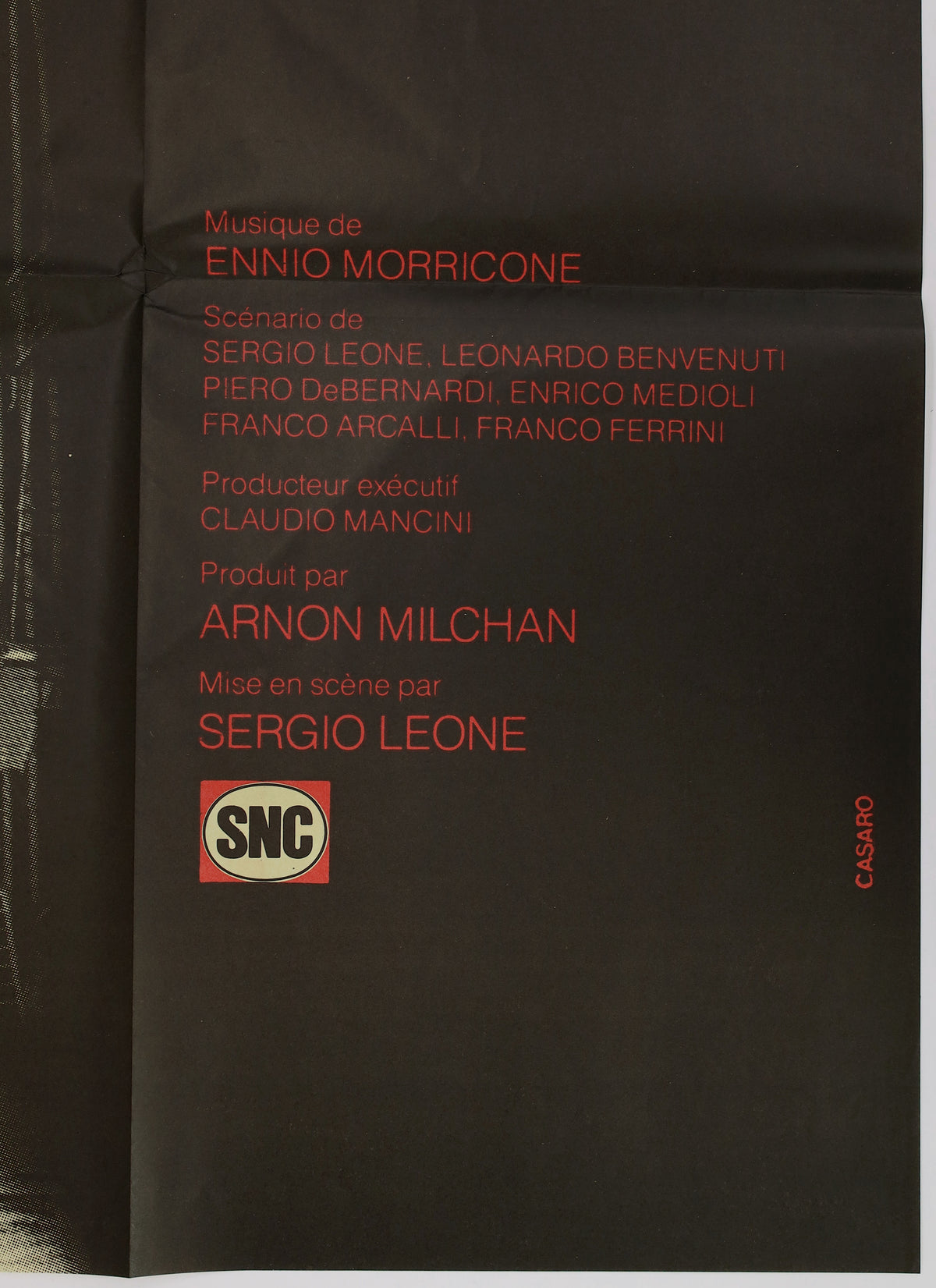 Close-up of the lower right portion showing red production credits, Ennio Morricone, Sergio Leone, SNC logo, and fold-related creasing.