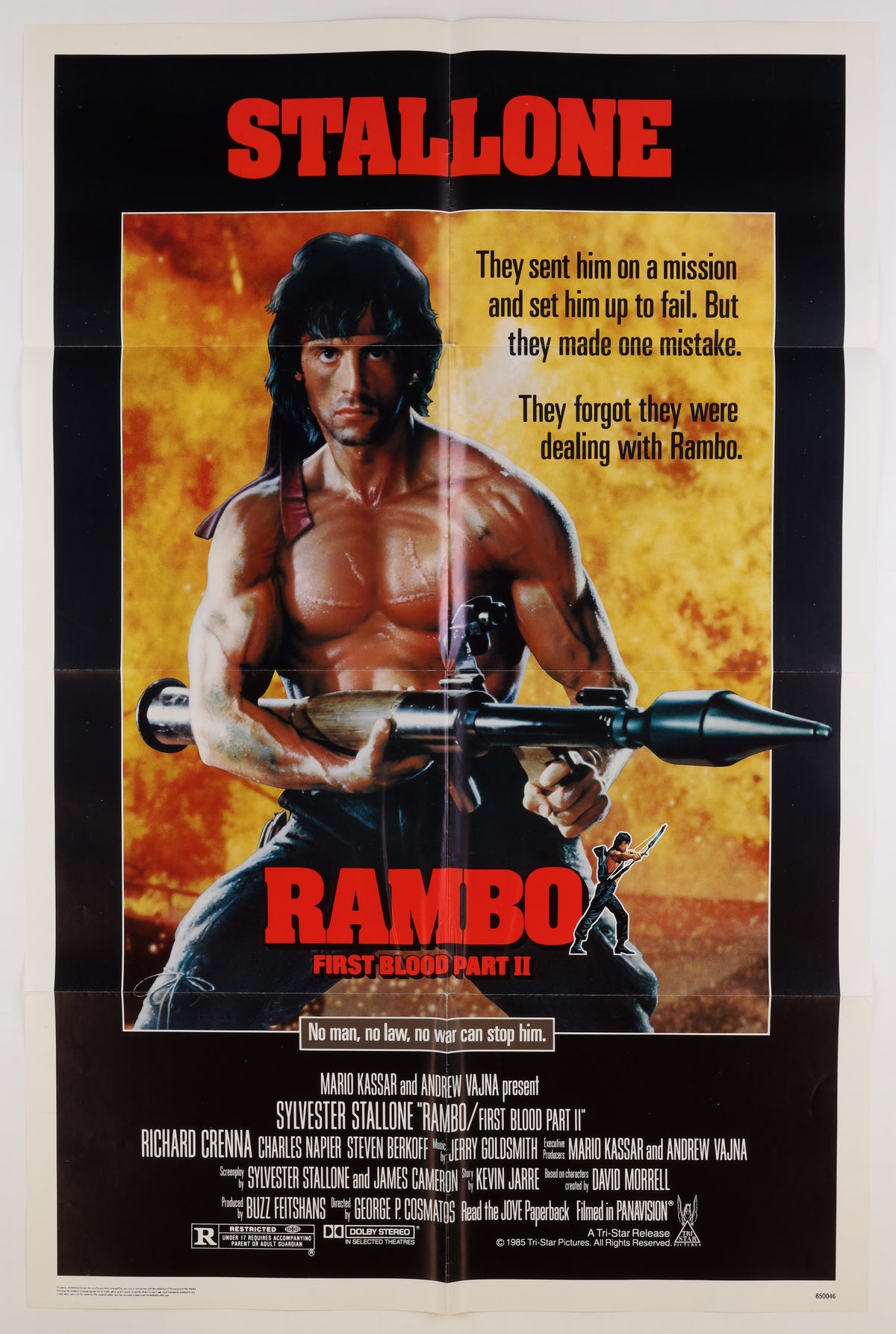 Front of the 1985 U.S. one sheet for Rambo: First Blood Part II, featuring Sylvester Stallone as Rambo holding a rocket launcher against a fiery background.