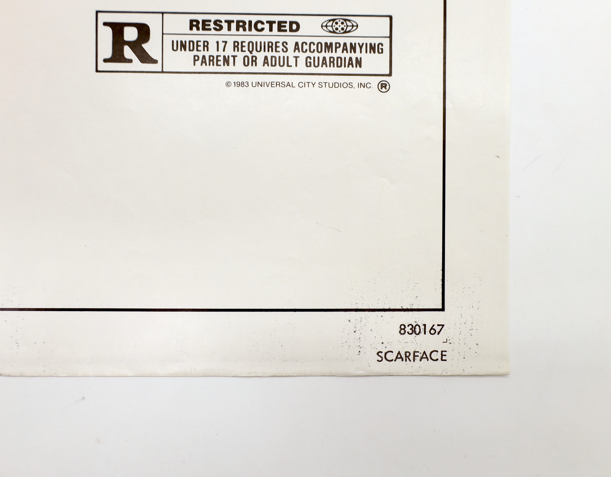 Close-up of Scarface (1983) one sheet movie poster showing R rating box, copyright information, and 830167 NSS number.