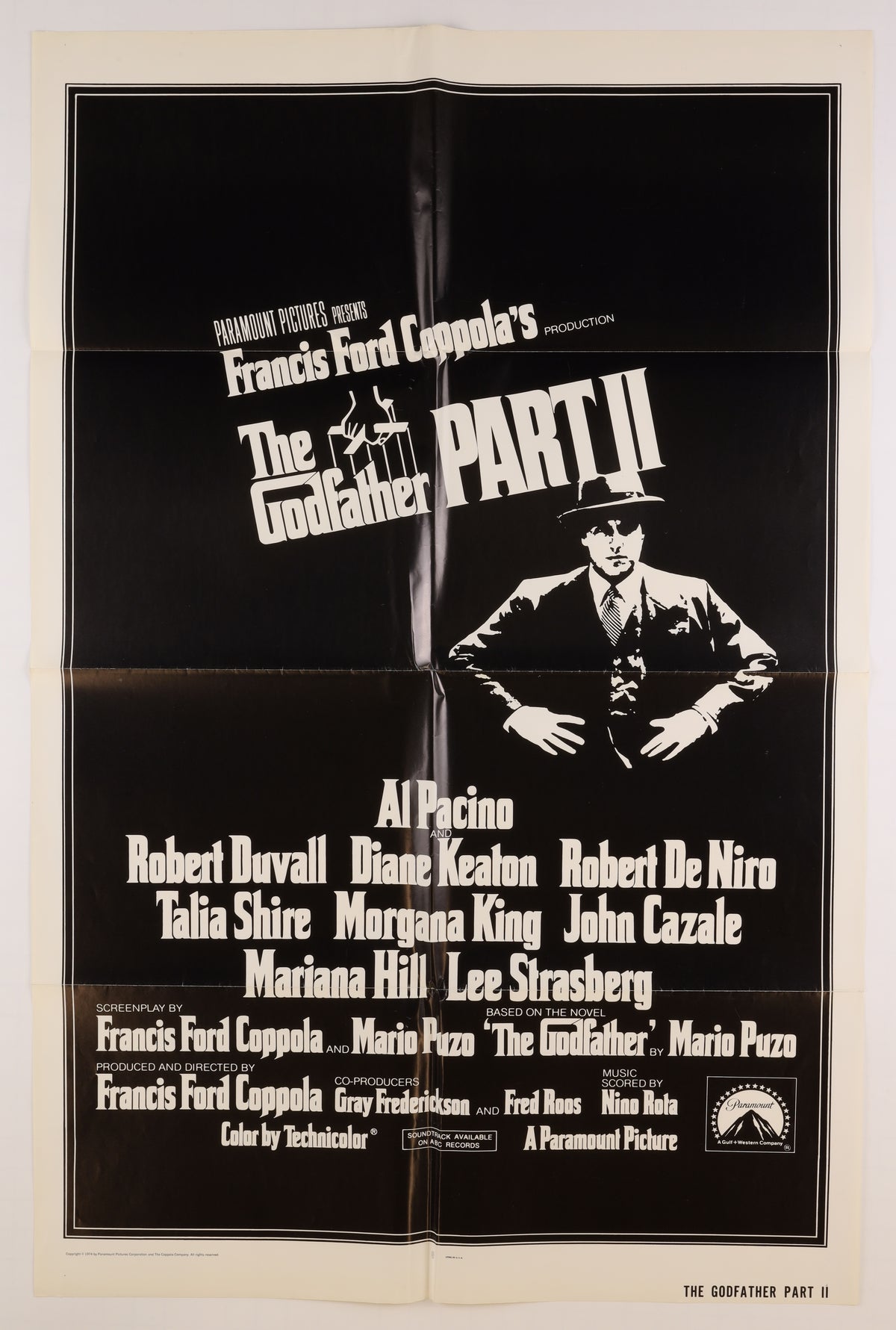 Front of a 1974 U.S. one sheet for The Godfather Part II, featuring the black-and-white Michael Corleone design, film title, cast, and credits.