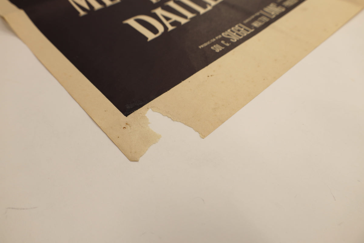 Detail of the There’s No Business Like Show Business Spanish one sheet poster showing a larger area of paper loss and edge damage at the lower-left corner.