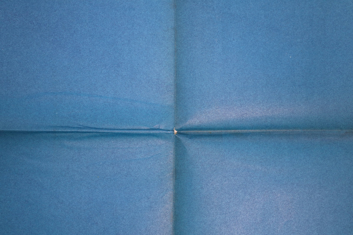 Close-up of folded French Traffic poster showing central fold intersection and small paper loss