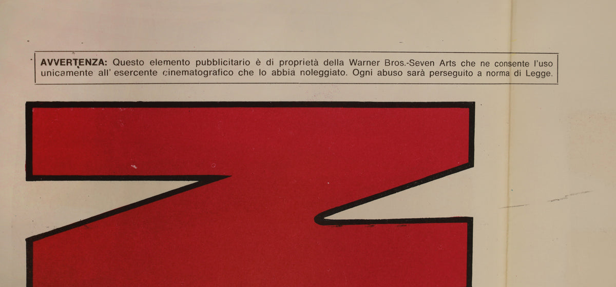 Close-up of the poster showing the Warner Bros.-Seven Arts ownership notice and red printed artwork with surface marks.