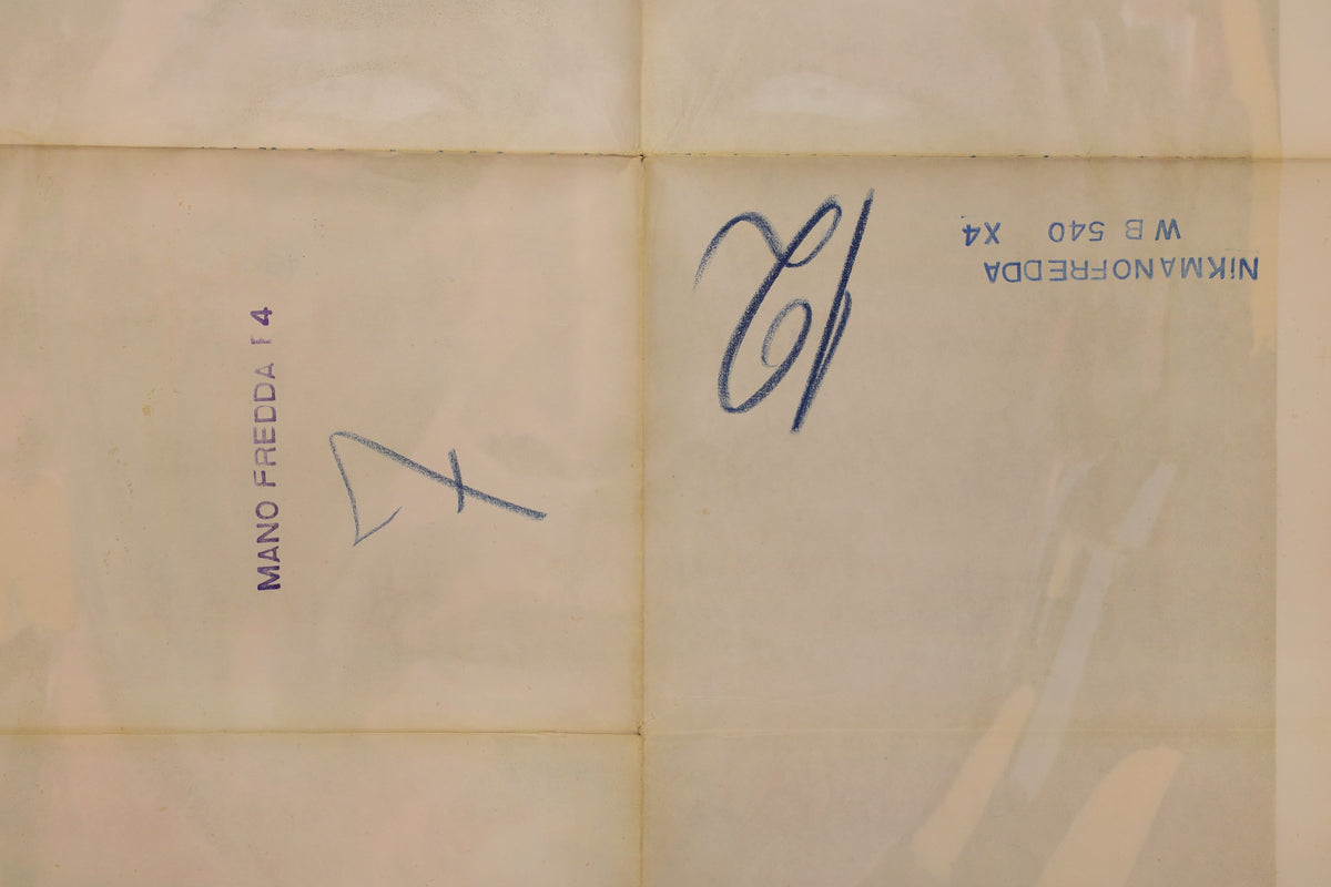 Close-up of the reverse showing fold intersections, toning, handwritten blue-ink markings, and faint bleed-through.